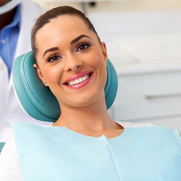 A middle-aged woman waiting for her tooth extraction in the dentist's chair